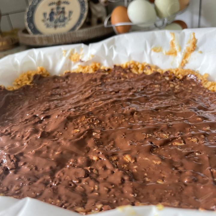 healthy rice crispy treats in dish with melted chocolate
