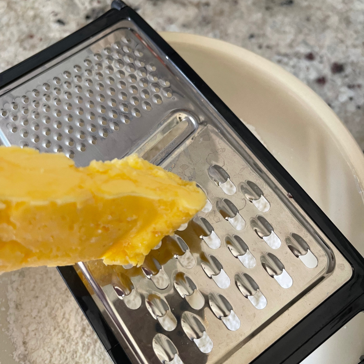 grating cold butter into flour