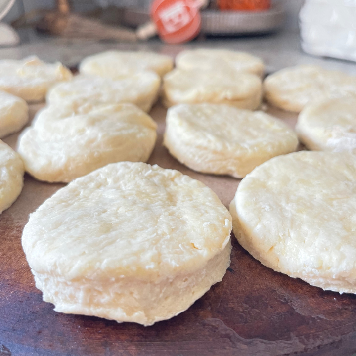 up close picture of raw sourdough biscuits on baking stone